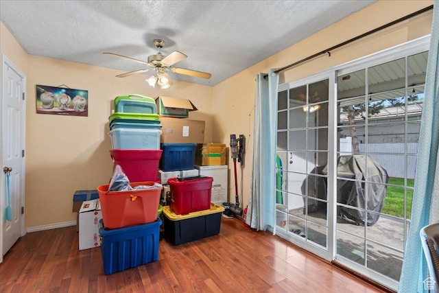 7638 S Redwood Rd Unit 17, West Jordan, UT 84084 - rec room with ceiling fan, wood finished floors, baseboards, a textured ceiling, and healthy amount of natural light
