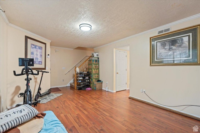7638 S Redwood Rd Unit 17, West Jordan, UT 84084 - exercise area featuring a textured ceiling, wood finished floors, crown molding, and baseboards