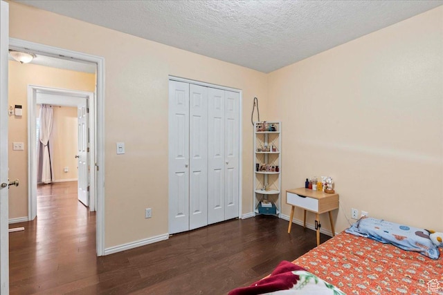 7638 S Redwood Rd Unit 17, West Jordan, UT 84084 - bedroom with wood finished floors, baseboards, a textured ceiling, and a closet
