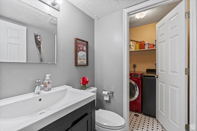 7638 S Redwood Rd Unit 17, West Jordan, UT 84084 - bathroom with a textured ceiling, independent washer and dryer, vanity, toilet, and tile patterned floors