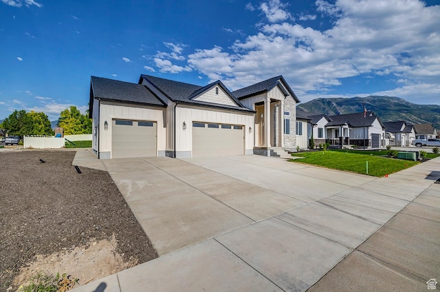 1605 S 1100 W, Payson, UT 84651 - view of front facade with board and batten siding, an attached garage, a mountain view, concrete driveway, and a front lawn