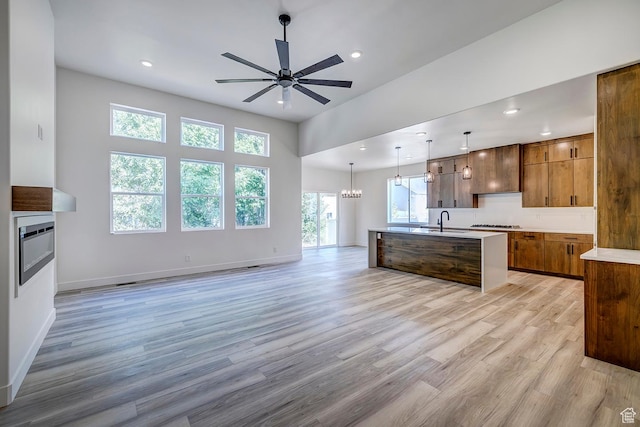 1605 S 1100 W, Payson, UT 84651 - kitchen featuring a ceiling fan, open floor plan, light wood-type flooring, brown cabinetry, and light countertops
