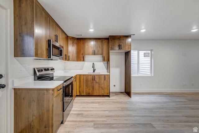 1605 S 1100 W, Payson, UT 84651 - kitchen with stainless steel appliances, light wood-type flooring, brown cabinetry, light countertops, and recessed lighting