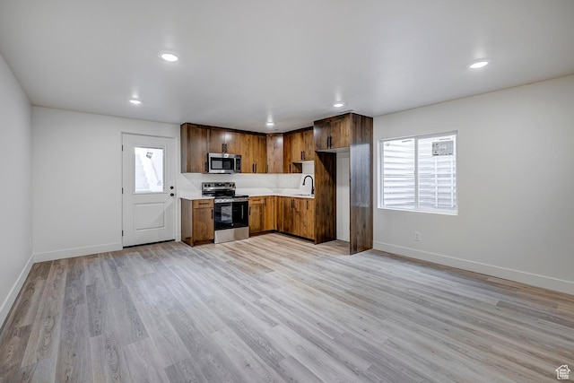 1605 S 1100 W, Payson, UT 84651 - kitchen featuring appliances with stainless steel finishes, light countertops, light wood-style floors, recessed lighting, and brown cabinetry