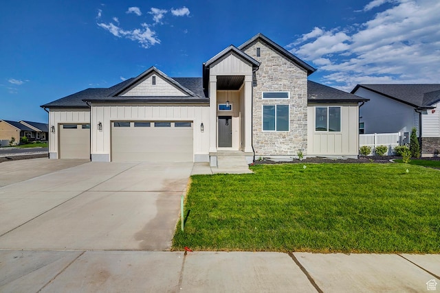 1605 S 1100 W, Payson, UT 84651 - view of front of home featuring board and batten siding, a garage, a front lawn, and stone siding