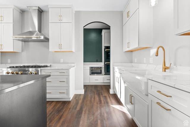 275 S 2800 E Unit 201, Spanish Fork, UT 84660 - kitchen with wall chimney range hood, dark wood-style floors, a sink, and white cabinetry