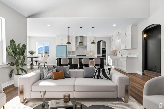 275 S 2800 E Unit 201, Spanish Fork, UT 84660 - living area with arched walkways, dark wood finished floors, baseboards, recessed lighting, and vaulted ceiling