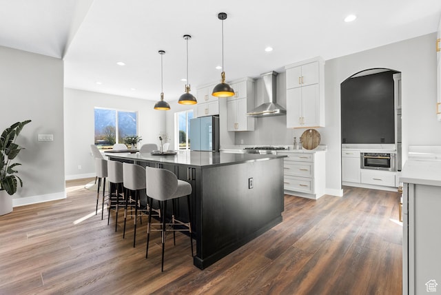 275 S 2800 E Unit 201, Spanish Fork, UT 84660 - kitchen with wall chimney range hood, refrigerator, wood finished floors, arched walkways, and recessed lighting