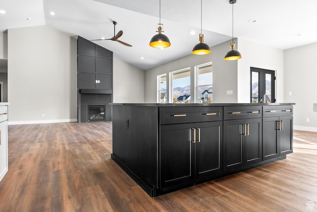 275 S 2800 E Unit 201, Spanish Fork, UT 84660 - kitchen with a fireplace, dark cabinets, wood finished floors, ceiling fan, and lofted ceiling