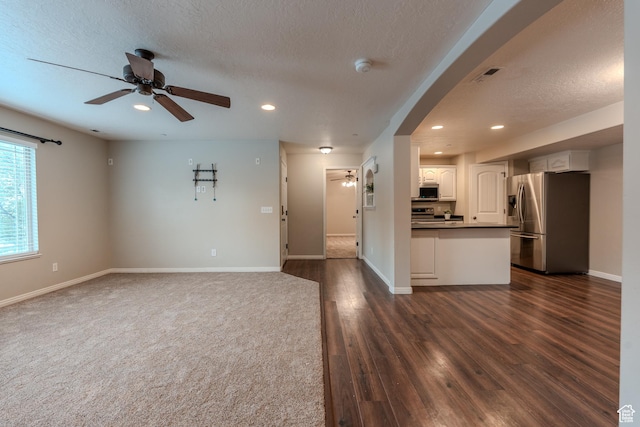 943 W 580 S Unit 97, Pleasant Grove, UT 84062 - unfurnished living room featuring a ceiling fan, recessed lighting, baseboards, arched walkways, and a textured ceiling