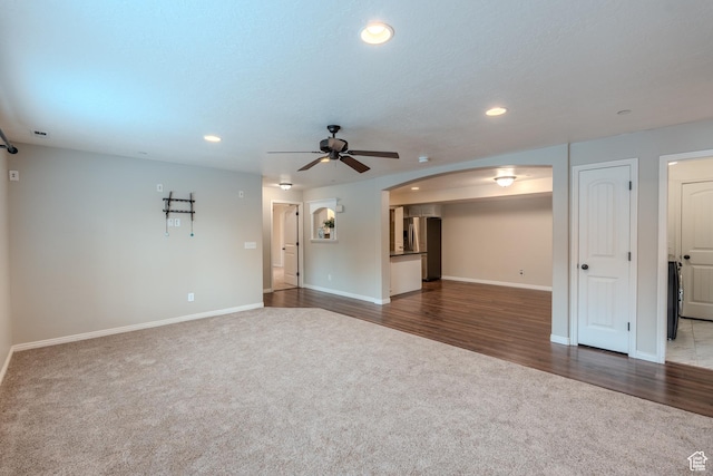 943 W 580 S Unit 97, Pleasant Grove, UT 84062 - unfurnished living room with carpet floors, baseboards, arched walkways, ceiling fan, and recessed lighting