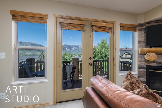 3521 N Moose Hollow Dr Unit 1202, Eden, UT 84310 - entryway featuring a mountain view, a fireplace, carpet floors, and baseboards
