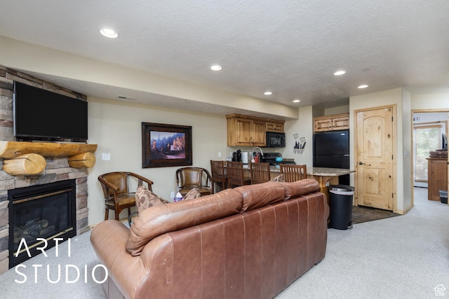 3521 N Moose Hollow Dr Unit 1202, Eden, UT 84310 - living area featuring light carpet, a stone fireplace, recessed lighting, and a textured ceiling