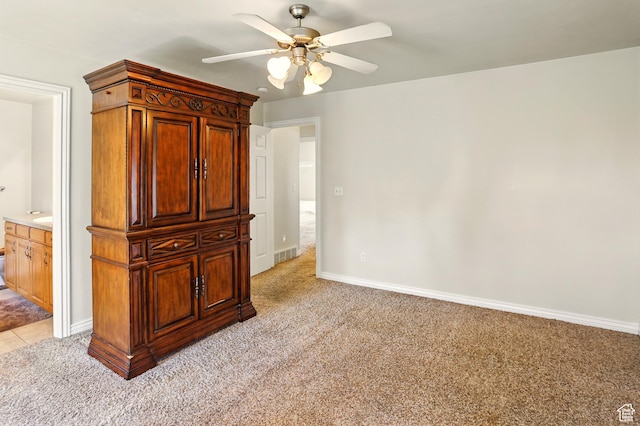 2865 W 3600 N, Farr West, UT 84404 - unfurnished bedroom featuring light colored carpet, baseboards, a ceiling fan, and connected bathroom