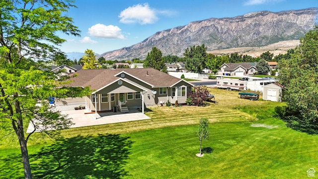 2865 W 3600 N, Farr West, UT 84404 - back of house featuring entry steps, a patio, a yard, and a mountain view