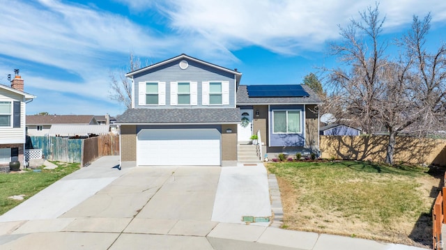 1962 W 12110 S, Riverton, UT 84065 - tri-level home featuring solar panels, an attached garage, a shingled roof, and concrete driveway