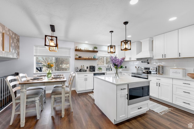 1962 W 12110 S, Riverton, UT 84065 - kitchen featuring custom range hood, stainless steel range with electric stovetop, built in microwave, dark wood-type flooring, and recessed lighting