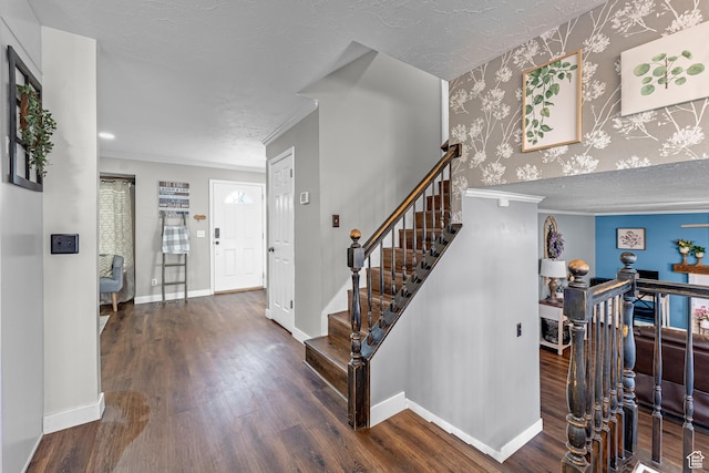 1962 W 12110 S, Riverton, UT 84065 - foyer entrance with wood finished floors, wallpapered walls, baseboards, ornamental molding, and a textured ceiling