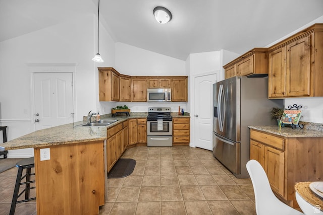 685 S 2220 W Unit 302, Pleasant Grove, UT 84062 - kitchen with appliances with stainless steel finishes, a sink, a peninsula, a kitchen bar, and brown cabinets
