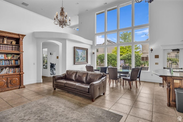 685 S 2220 W Unit 302, Pleasant Grove, UT 84062 - living room with a towering ceiling, light tile patterned floors, arched walkways, plenty of natural light, and a chandelier