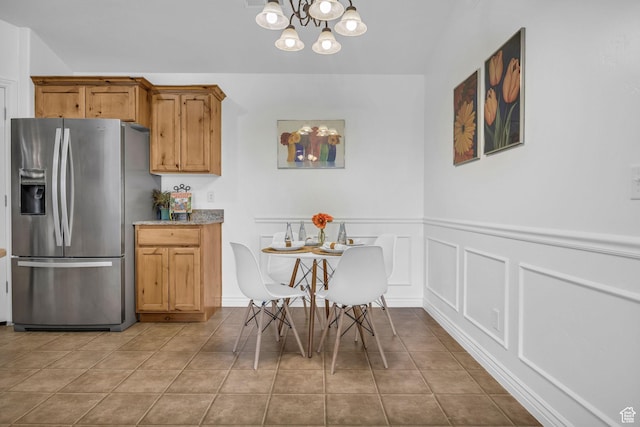 685 S 2220 W Unit 302, Pleasant Grove, UT 84062 - dining room featuring a chandelier, a wainscoted wall, a decorative wall, and tile patterned floors