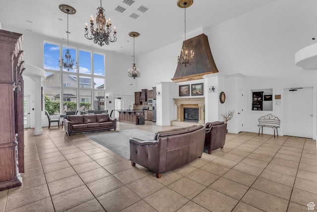 685 S 2220 W Unit 302, Pleasant Grove, UT 84062 - living room featuring a chandelier, a high ceiling, light tile patterned floors, a glass covered fireplace, and crown molding
