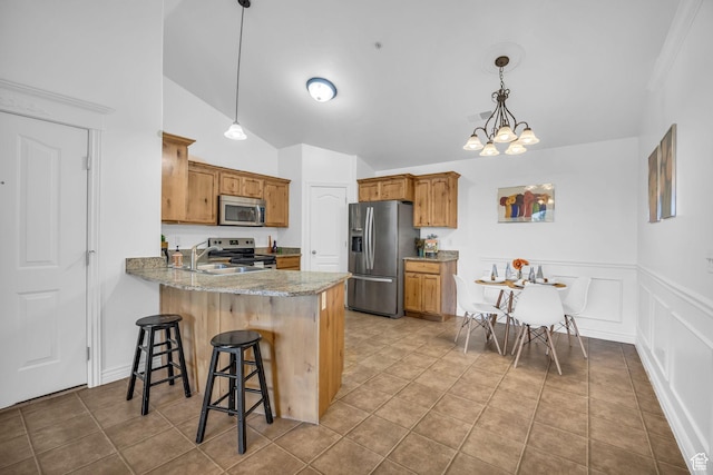 685 S 2220 W Unit 302, Pleasant Grove, UT 84062 - kitchen with appliances with stainless steel finishes, a sink, a peninsula, brown cabinetry, and a breakfast bar area