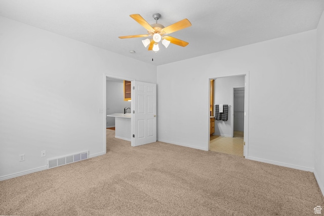 12482 S Tithing Point Dr, Riverton, UT 84065 - unfurnished bedroom featuring carpet flooring, baseboards, a spacious closet, ceiling fan, and a sink