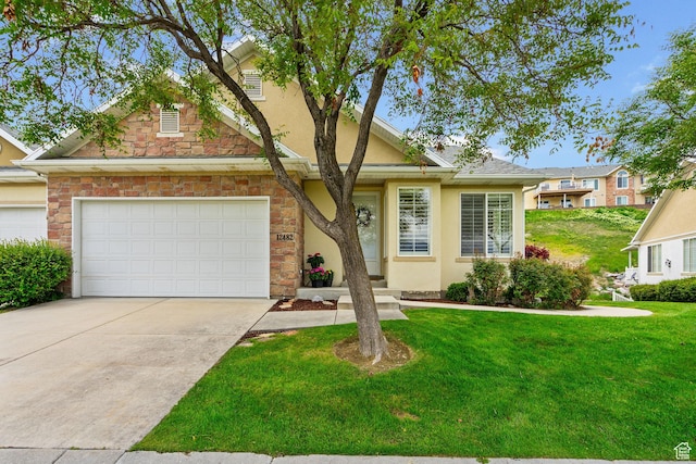 12482 S Tithing Point Dr, Riverton, UT 84065 - view of front of property with stucco siding, a front lawn, driveway, stone siding, and an attached garage