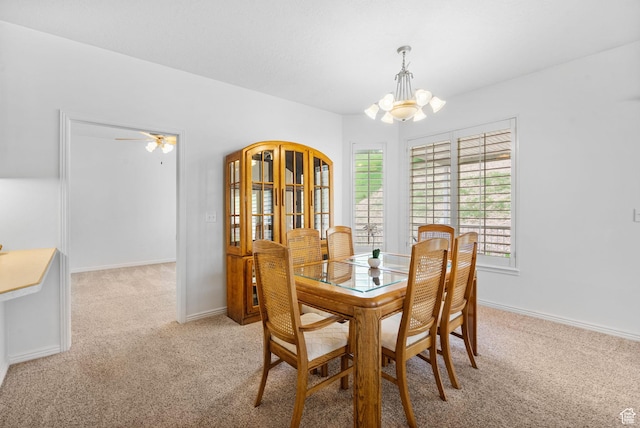 12482 S Tithing Point Dr, Riverton, UT 84065 - dining space featuring a chandelier, light colored carpet, and baseboards