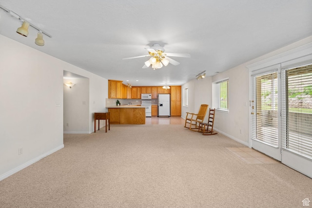 12482 S Tithing Point Dr, Riverton, UT 84065 - living room with a ceiling fan, baseboards, light carpet, and track lighting