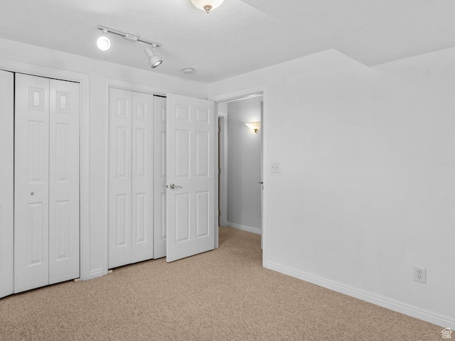 12482 S Tithing Point Dr, Riverton, UT 84065 - unfurnished bedroom featuring carpet floors, multiple closets, and baseboards