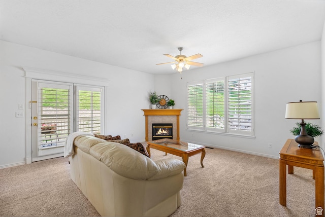 12482 S Tithing Point Dr, Riverton, UT 84065 - carpeted living room featuring plenty of natural light, ceiling fan, a glass covered fireplace, and baseboards