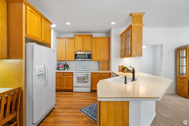 12482 S Tithing Point Dr, Riverton, UT 84065 - kitchen featuring white appliances, a sink, a peninsula, light countertops, and recessed lighting