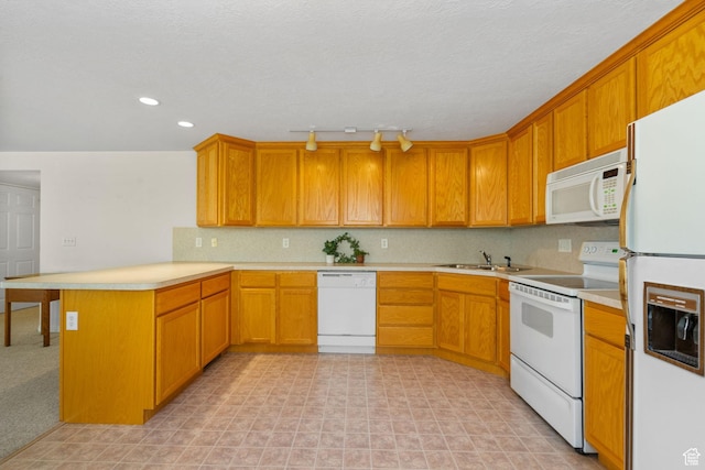 12482 S Tithing Point Dr, Riverton, UT 84065 - kitchen featuring white appliances, a peninsula, light countertops, brown cabinets, and recessed lighting