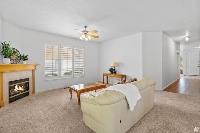 12482 S Tithing Point Dr, Riverton, UT 84065 - living area with carpet floors, ceiling fan, a fireplace, and baseboards