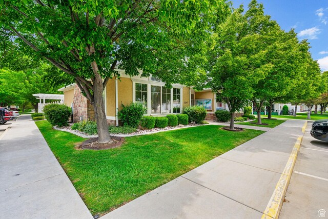 12482 S Tithing Point Dr, Riverton, UT 84065 - obstructed view of property with stucco siding and a front yard