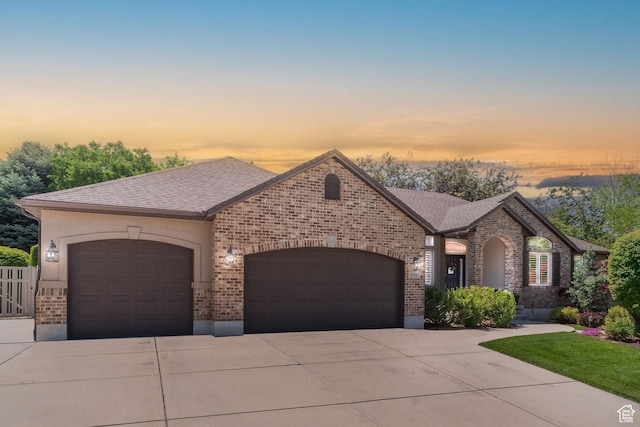 250 E 950 N, Kaysville, UT 84037 - french country style house featuring an attached garage, brick siding, driveway, and a shingled roof