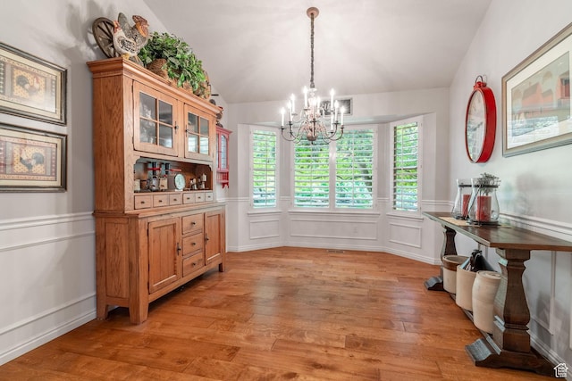 250 E 950 N, Kaysville, UT 84037 - dining room with a chandelier, a decorative wall, light wood finished floors, wainscoting, and lofted ceiling