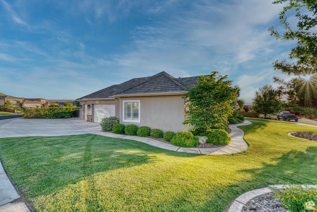 3207 W 2650 S, Hurricane, UT 84737 - view of side of home featuring driveway, a garage, a lawn, and stucco siding