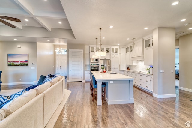 3207 W 2650 S, Hurricane, UT 84737 - kitchen featuring open floor plan, premium range hood, stainless steel appliances, a sink, and recessed lighting