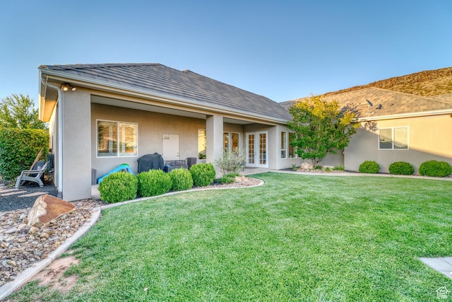 3207 W 2650 S, Hurricane, UT 84737 - rear view of house featuring french doors, stucco siding, and a yard