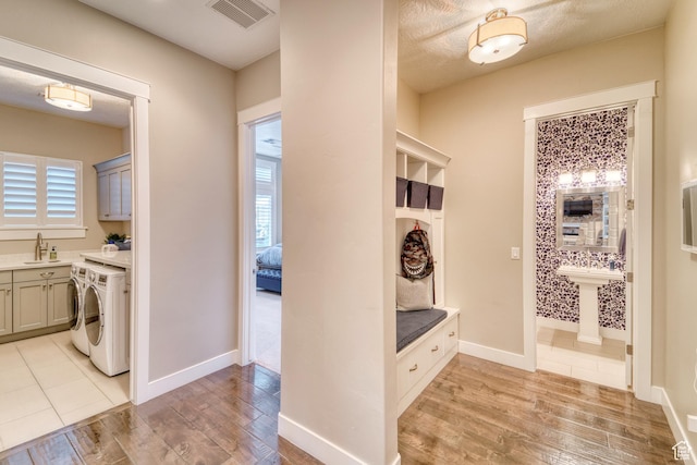 3207 W 2650 S, Hurricane, UT 84737 - mudroom featuring a sink, light wood-type flooring, independent washer and dryer, and baseboards