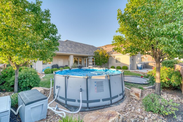 3207 W 2650 S, Hurricane, UT 84737 - back of property featuring an outdoor pool, stucco siding, and roof with shingles