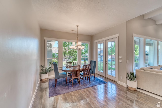 3207 W 2650 S, Hurricane, UT 84737 - dining area featuring baseboards, wood finished floors, a chandelier, and a textured ceiling