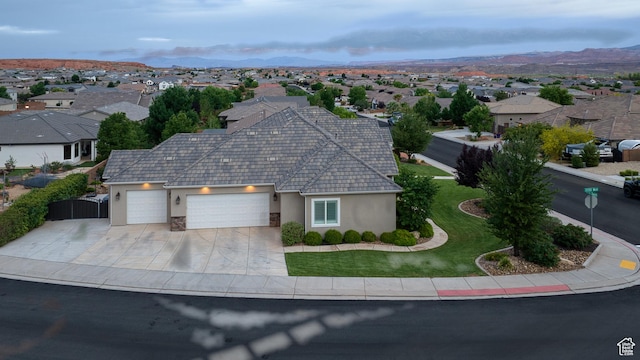 3207 W 2650 S, Hurricane, UT 84737 - view of front facade with stucco siding, a garage, a residential view, concrete driveway, and a mountain view