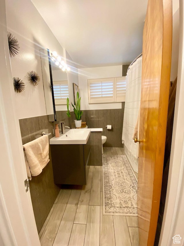 1321 Darling St, Ogden, UT 84403 - bathroom with tile walls, vanity, a wainscoted wall, toilet, and wood finished floors