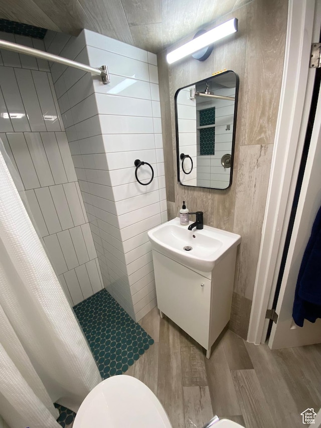 1321 Darling St, Ogden, UT 84403 - full bathroom with tiled shower, wood finished floors, vanity, and toilet