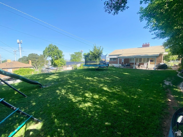 1321 Darling St, Ogden, UT 84403 - view of yard featuring a trampoline, a patio area, and a playground