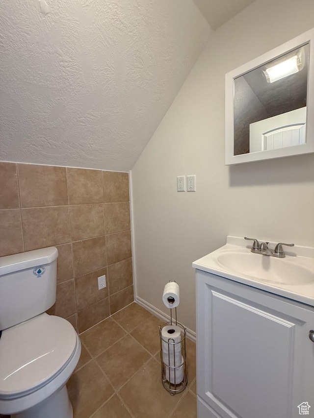 346 Columbia Dr, East Carbon, UT 84520 - half bathroom featuring lofted ceiling, toilet, vanity, tile walls, and a textured ceiling